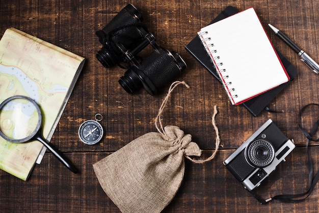 Top view travel accessories on wooden background