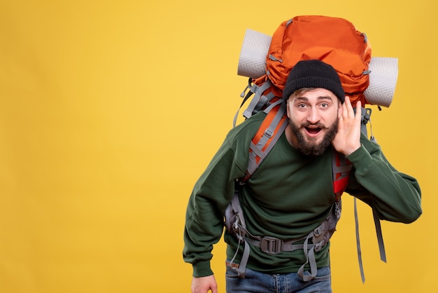 Top view of travel concept with young guy with packpack listening to the last gossiping