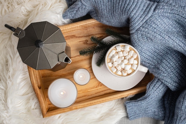 Free photo top view of tray with candles and cup of hot cocoa with marshmallows