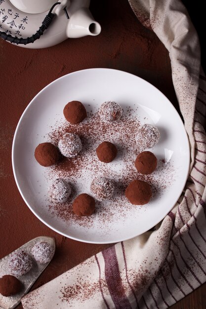 Top view of truffles and chocolates with coconut