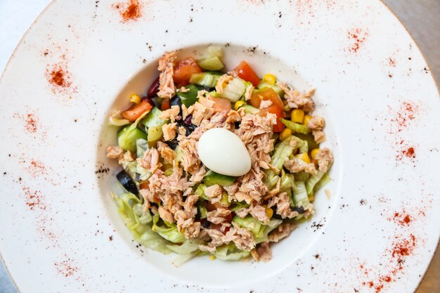 Top view tuna salad with boiled egg on a plate