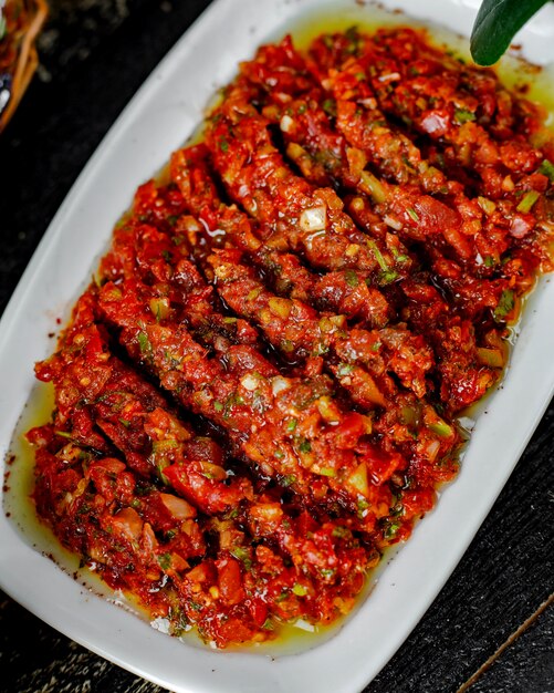 Top view of turkish side dish with bell pepper onion tomato herbs mixture in olive oil