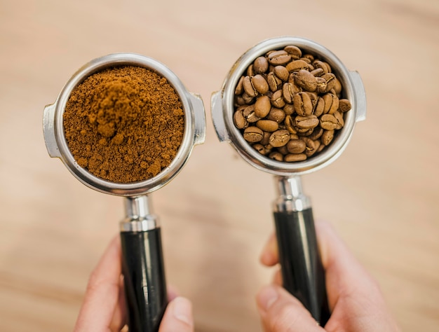 Free Photo top view of two coffee machine cups held by barista