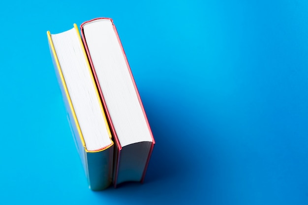 Free Photo top view of two decorative books with blue background