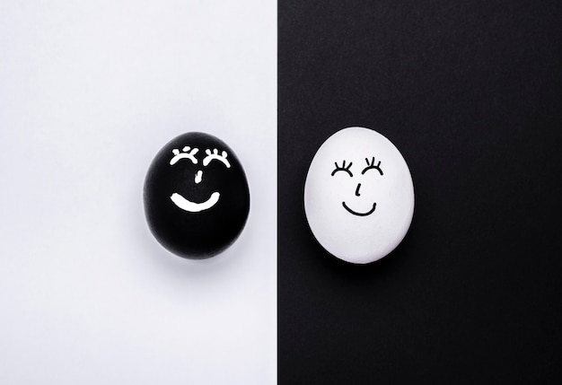 Free Photo top view of two different colored eggs with faces for black lives matter movement