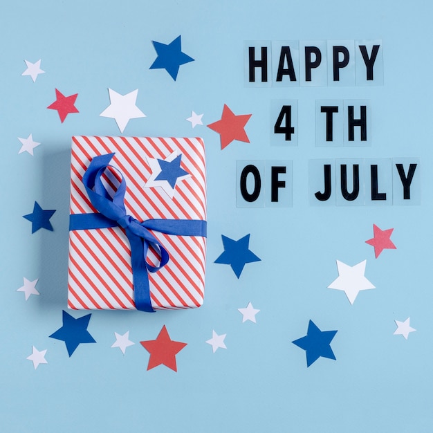 Free Photo top view usa flag wrapped gift with happy 4th of july letters