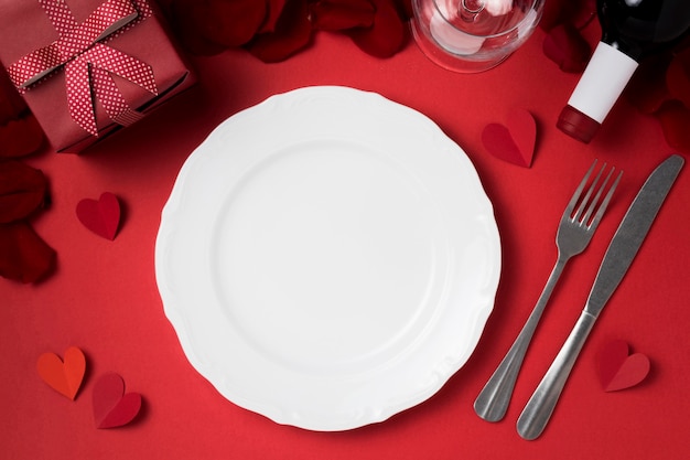 Top view of valentine's day table set with plate and gift