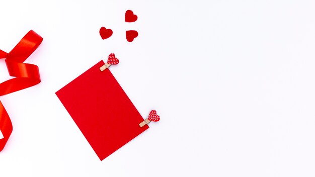 Top view of valentines day paper with hearts and ribbon