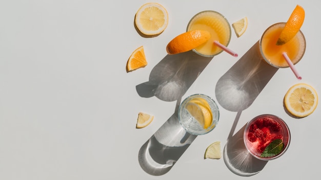 Top view variety of containers with natural juice and water