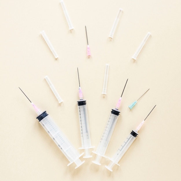 Top view variety of syringes with needles on the table