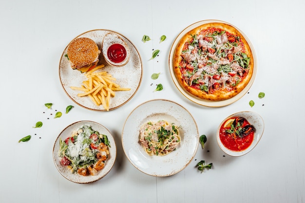 Free photo top view of the various delicious and tasty fresh food on a wooden white surface