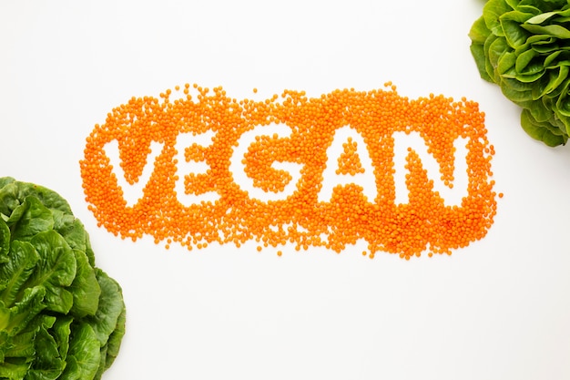 Free Photo top view vegan lettering on white background