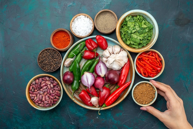 Free Photo top view vegetable composition onions garlics greens and peppers on dark desk vegetable food meal salad color photo