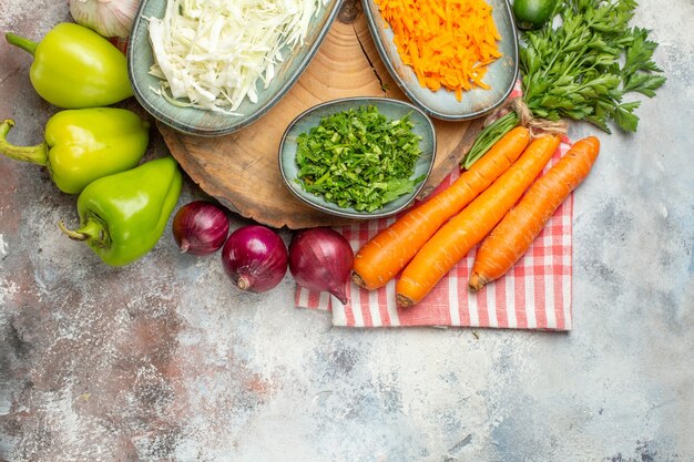 Top view vegetable composition sliced and whole vegetables on a white background