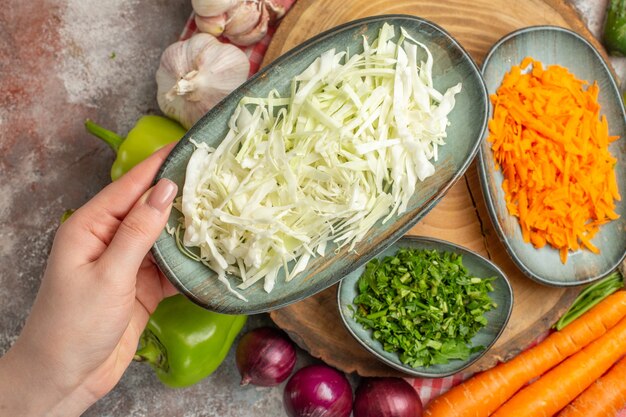 Top view vegetable composition sliced and whole vegetables on white background