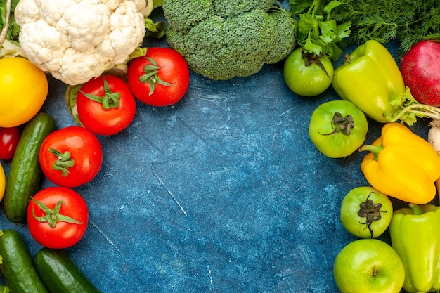 Top view vegetable composition with fresh fruits on blue table