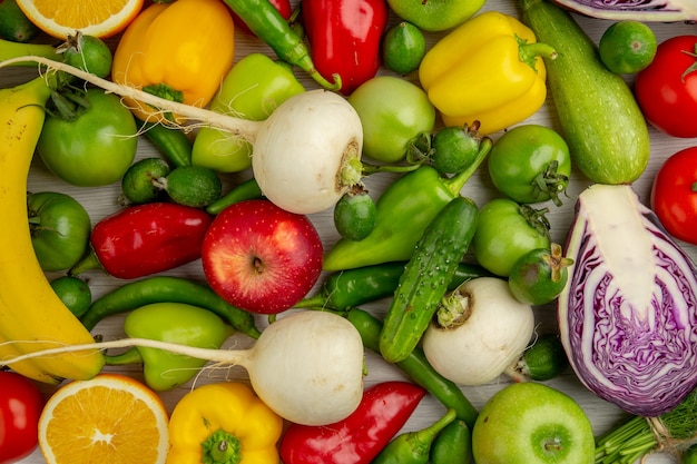 Top view vegetable composition with fruits on white background