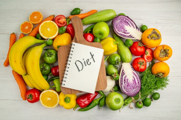 Top view vegetable composition with fruits on white background