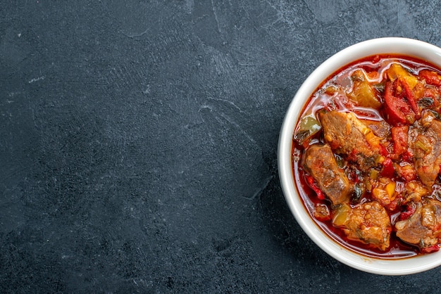 Free Photo top view vegetable soup with meat inside plate on a dark grey