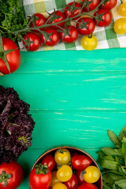 Free photo top view of vegetables as green mint leaves tomato basil on green surface with copy space