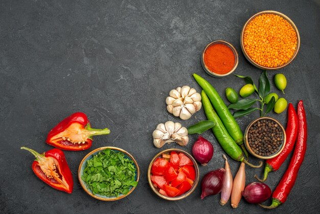 Top view of vegetables lentil herbs spices onion hot pepper tomatoes bell peppers