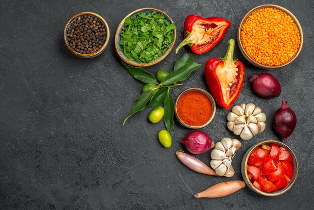 Top view of vegetables lentil herbs tomatoes bell peppers spices onion garlic citrus fruits