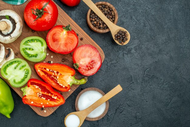 Top view vegetables mushrooms tomatoes red bell peppers on cutting board