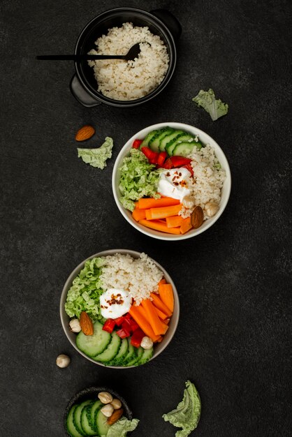 Top view veggie salad bowls with couscous and nuts