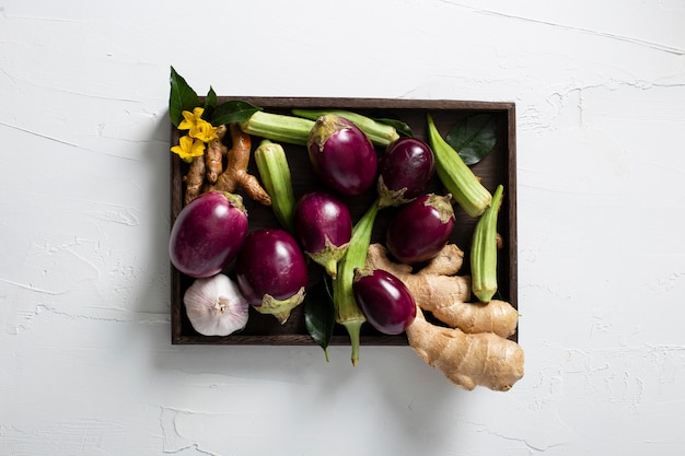 Top view veggies assortment in wooden tray