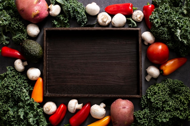 Free photo top view veggies mix with empty wooden tray