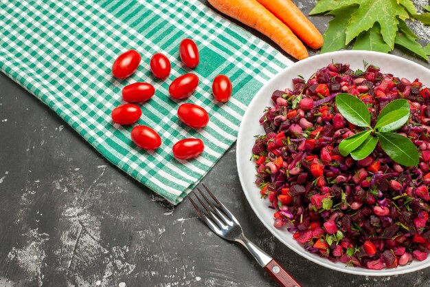 Top view vinaigrette salad with beet and beans on dark surface