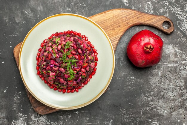 Top view vinaigrette salad with beets and beans on dark surface