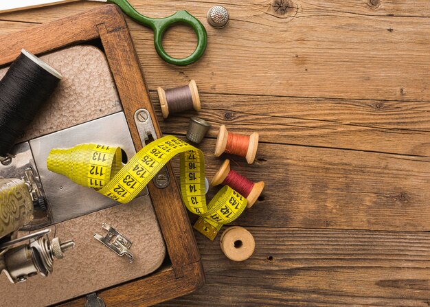 Top view of vintage sewing machine with thread and measuring tape