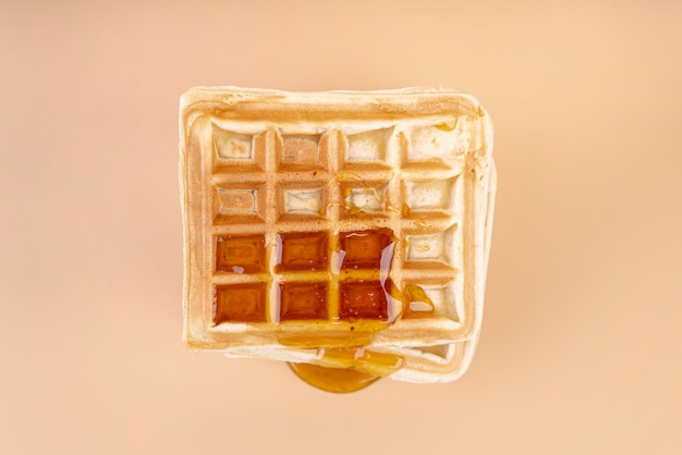 Free Photo top view of waffle with dripping honey