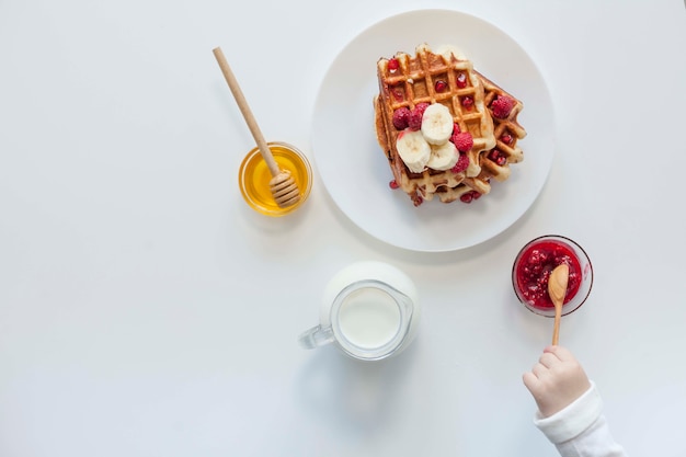 Top view waffle with jam,milk and honey