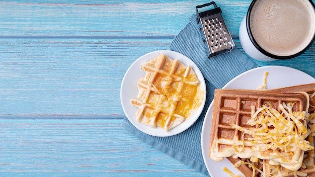 Free Photo top view of waffles on plate with grated cheese