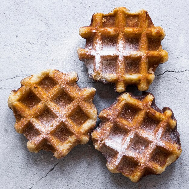 Top view of waffles with powdered sugar on top