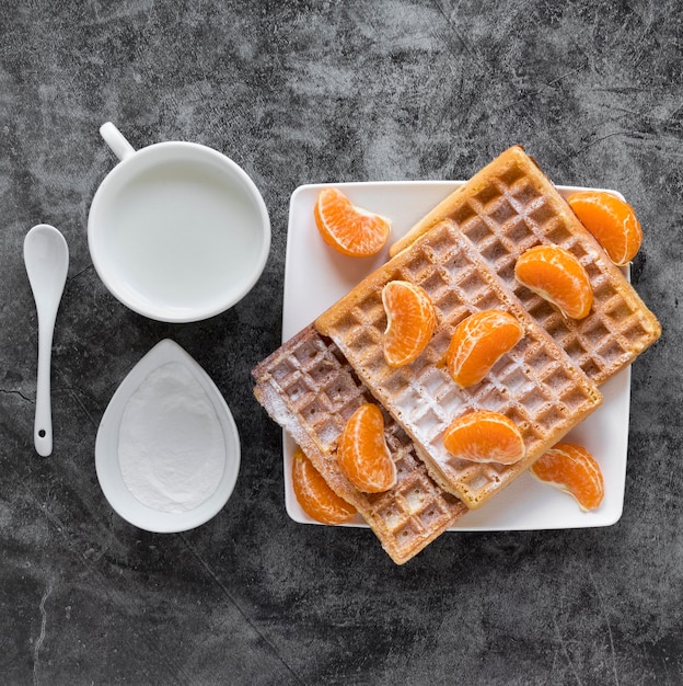 Free Photo top view of waffles with tangerines and milk