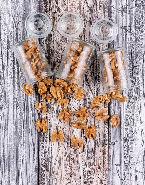 Top view walnuts in jars on wooden  vertical