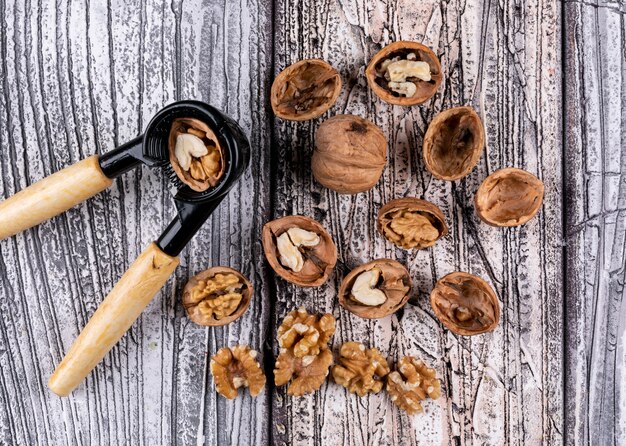 Top view walnuts and nutcracker on wooden  horizontal