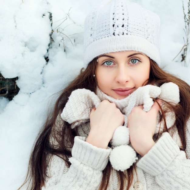 Free photo top view of warm woman lying on the snowy ground