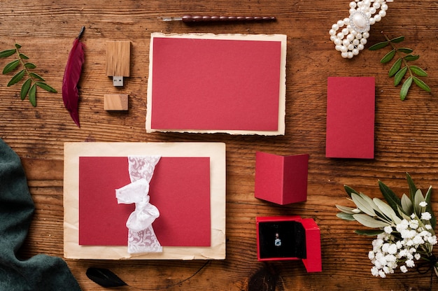 Top view wedding card and engagement ring on table