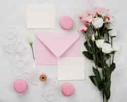 Free photo top view wedding invitation cards with flowers