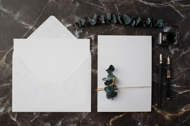 Top view of wedding paper and envelope with dried plants