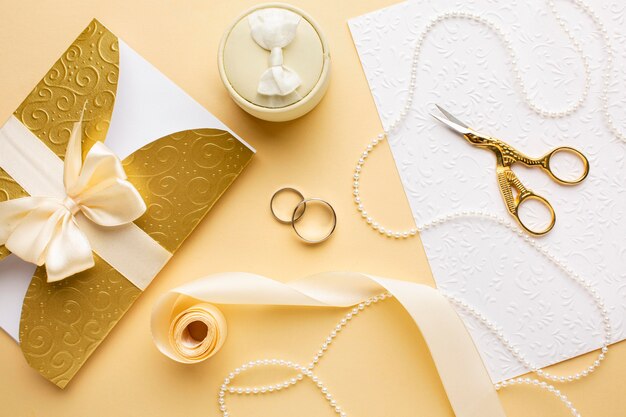 Top view wedding rings and ribbon with scissors