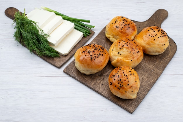 Free Photo top view white cheese along with greens and buns on the bright background food meal bread bun