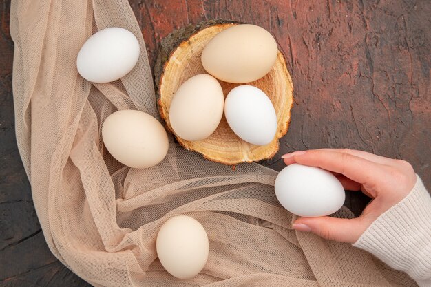 Top view white chicken eggs on dark table