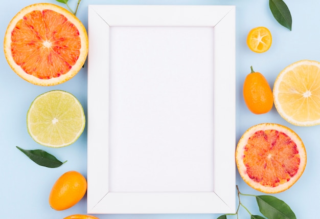 Free photo top view white frame with organic fruits