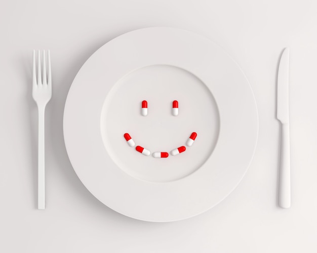 Top view white plate with pills forming a smile fork and knife