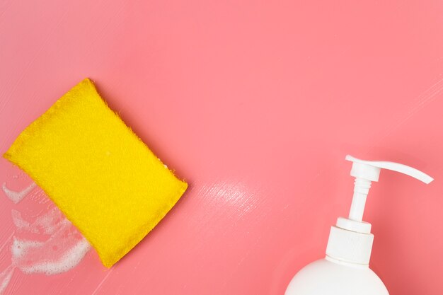 Top view white soap bottle and sponge